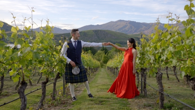 Bride & groom in between grape vines in Wanaka