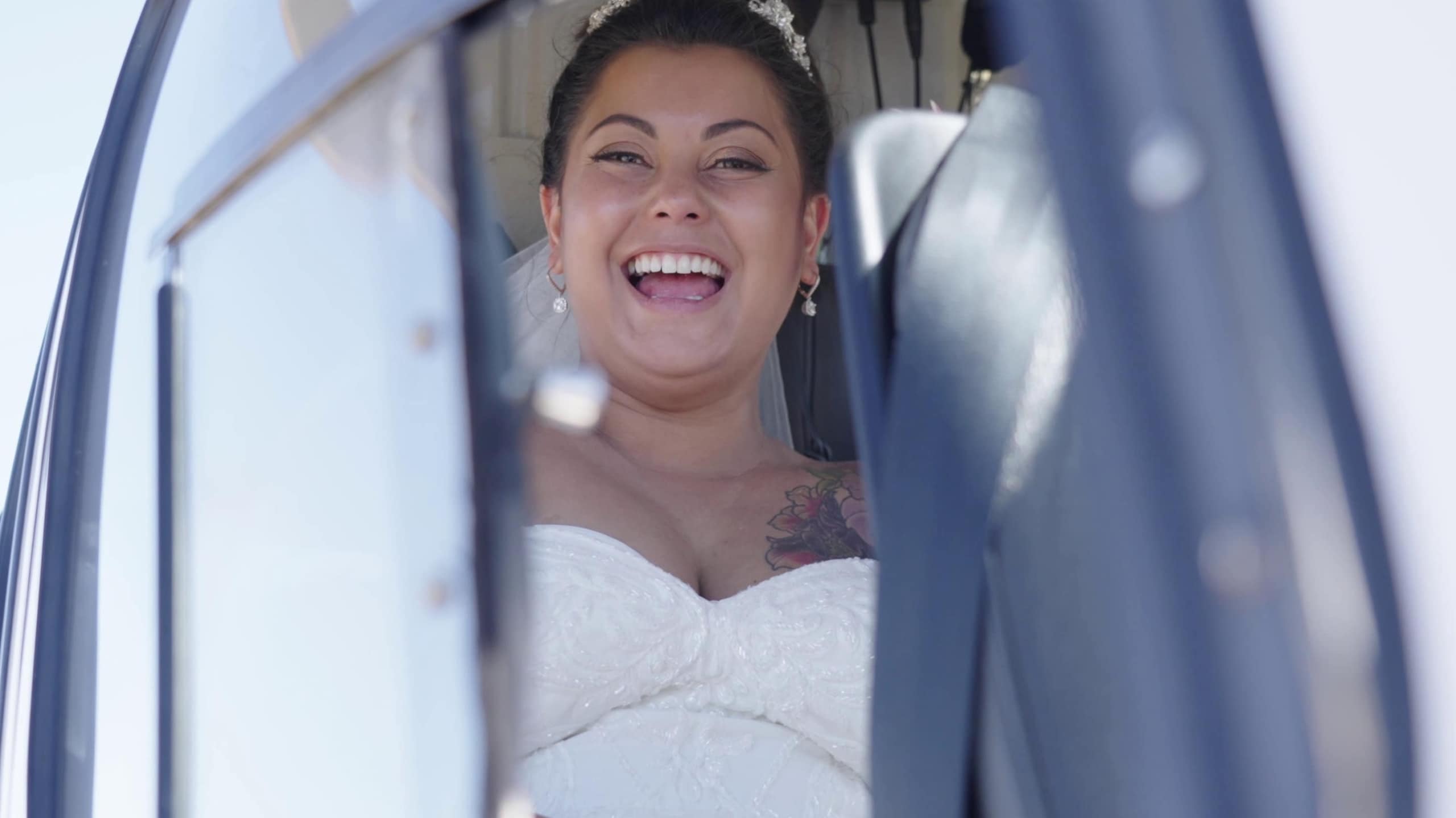 Bride laughing inside helicopter
